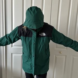 Women’s The North Face Goretex hooded mountain jacket in green and black.